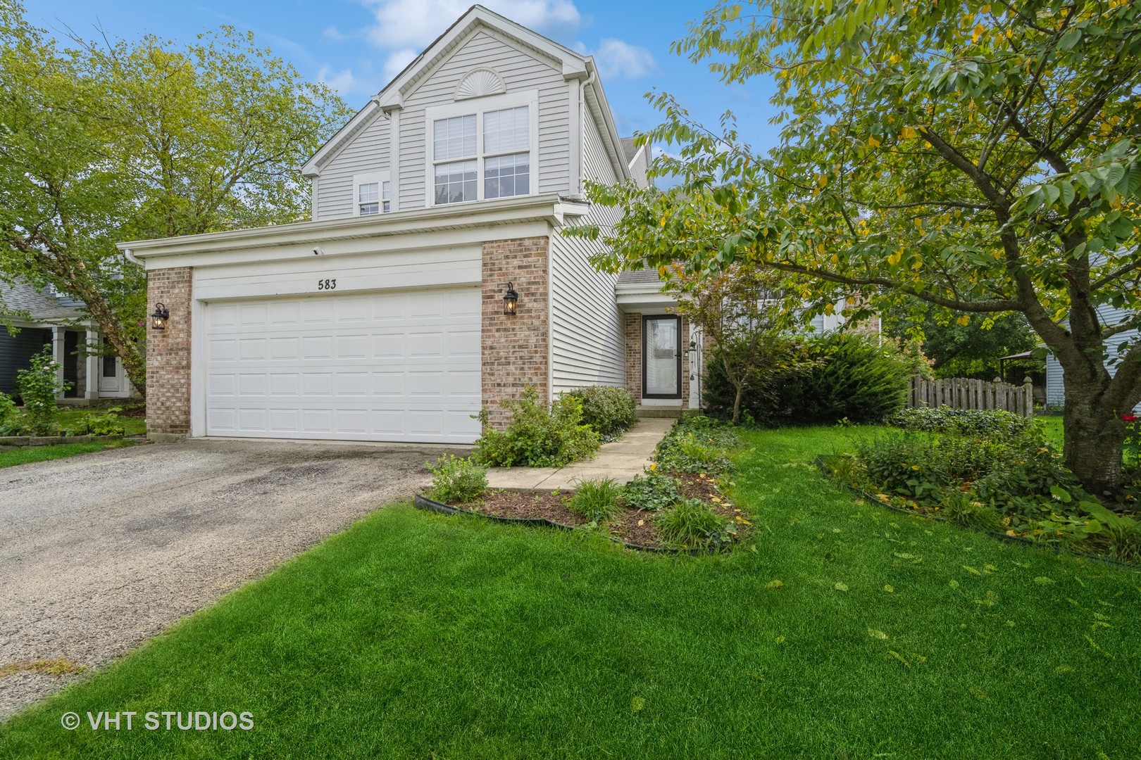 a view of backyard of house with green space