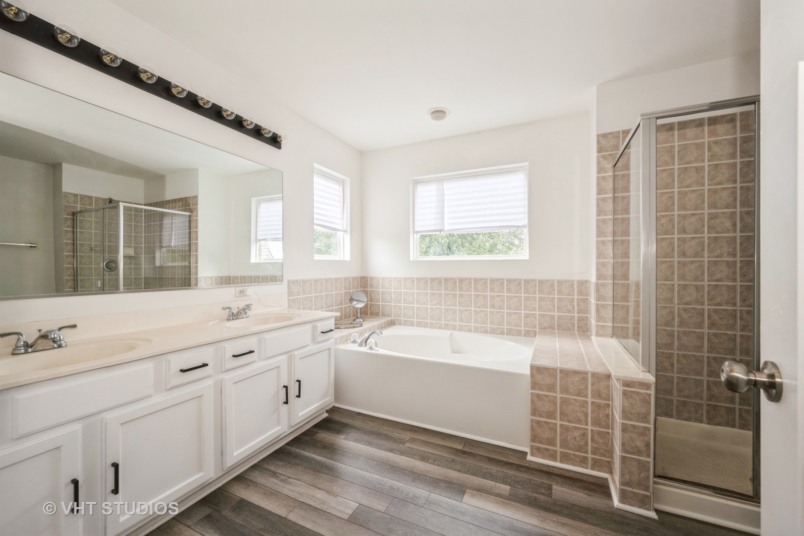 583 Greystone Lane Bolingbrook, IL 60440 - Photo 17 of 28 a bathroom with a double vanity sink large mirror and a bathtub