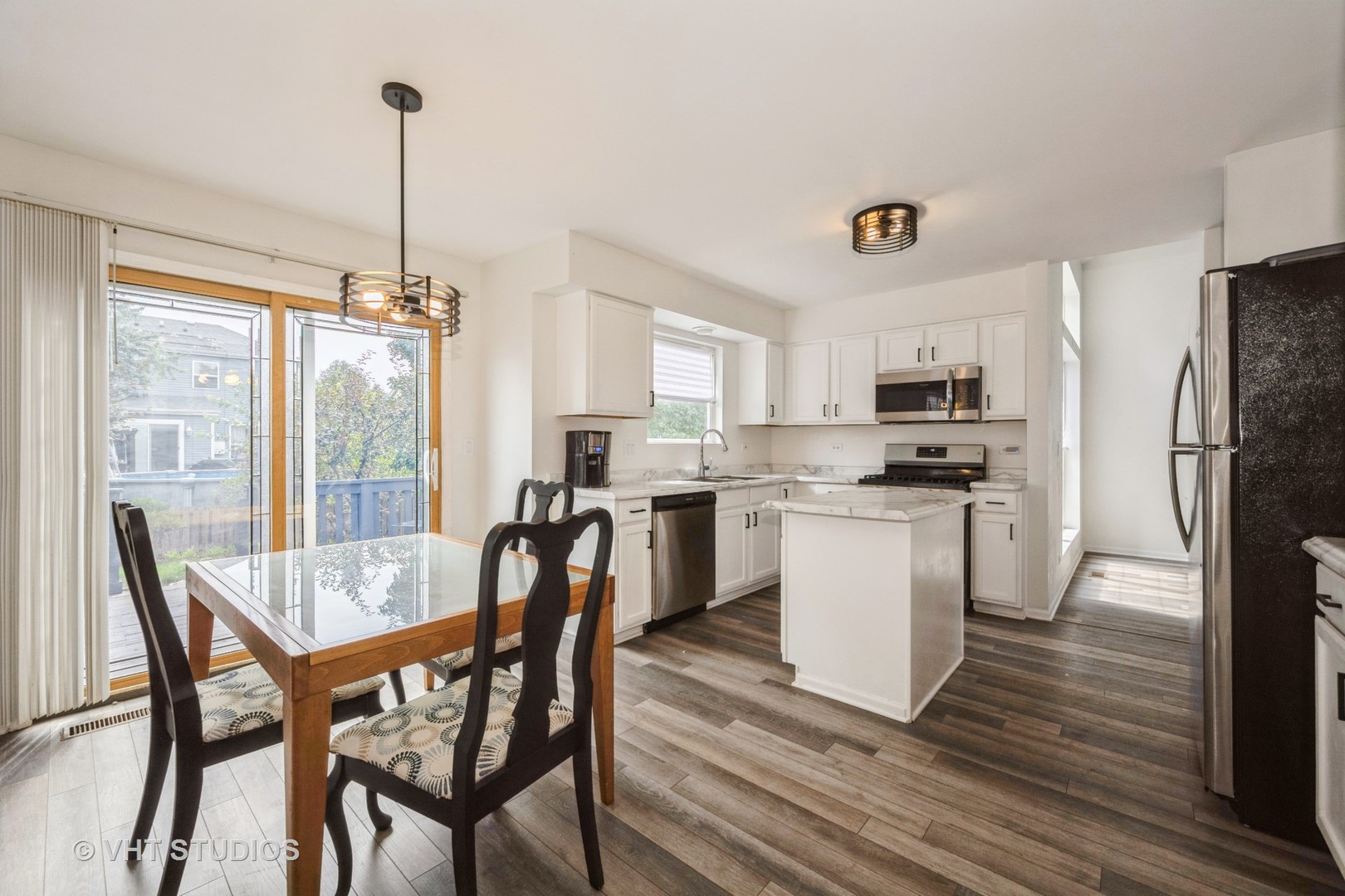 583 Greystone Lane Bolingbrook, IL 60440 - Photo 8 of 28 a kitchen with refrigerator cabinets dining table and chairs