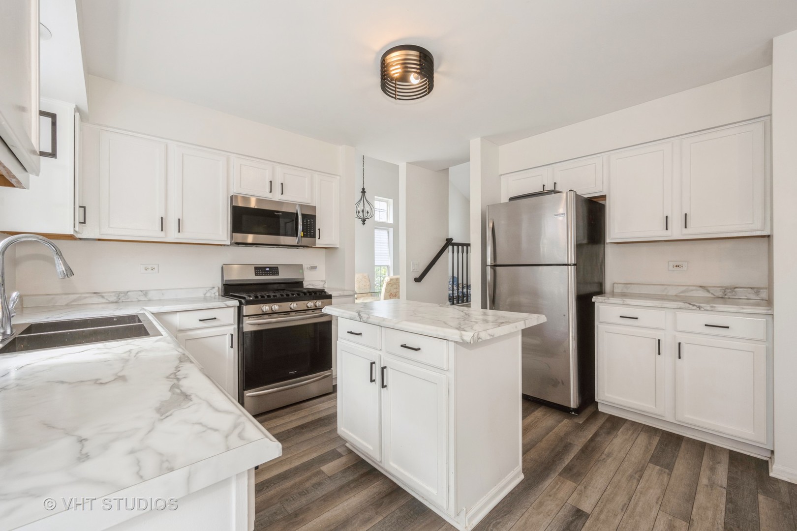 583 Greystone Lane Bolingbrook, IL 60440 - Photo 9 of 28 a kitchen with white cabinets and stainless steel appliances