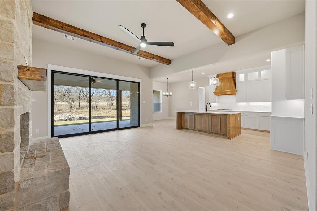 1053 Llano Way Poolville, TX 76487 - Photo 7 of 40 a large room with a large window and chandelier