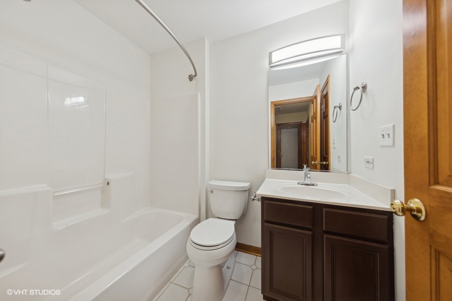 1114 Taft Avenue Wheaton, IL 60189 - Photo 13 of 24 a bathroom with a sink a toilet and shower