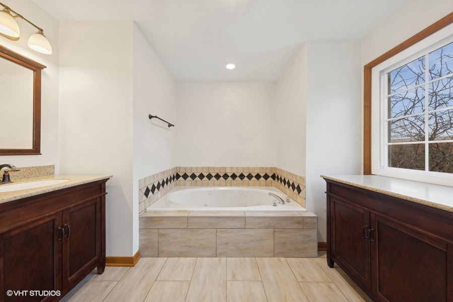 1114 Taft Avenue Wheaton, IL 60189 - Photo 17 of 24 a bathroom with a bathtub a sink and a window