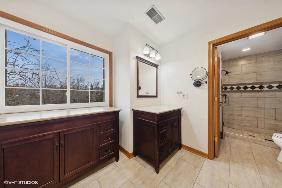 1114 Taft Avenue Wheaton, IL 60189 - Photo 18 of 24 a spacious bathroom with a granite countertop sink mirror and shower