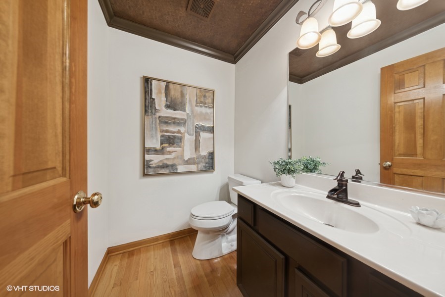 1114 Taft Avenue Wheaton, IL 60189 - Photo 3 of 24 a bathroom with a sink a toilet and a mirror