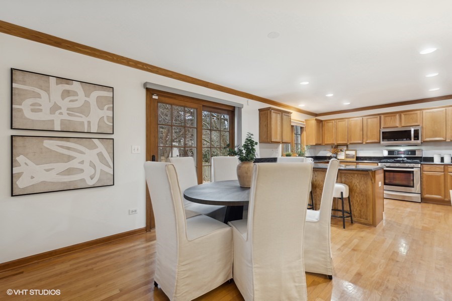 1114 Taft Avenue Wheaton, IL 60189 - Photo 6 of 24 a kitchen with stainless steel appliances kitchen island granite countertop a refrigerator a stove top oven and a dining table with wooden floor