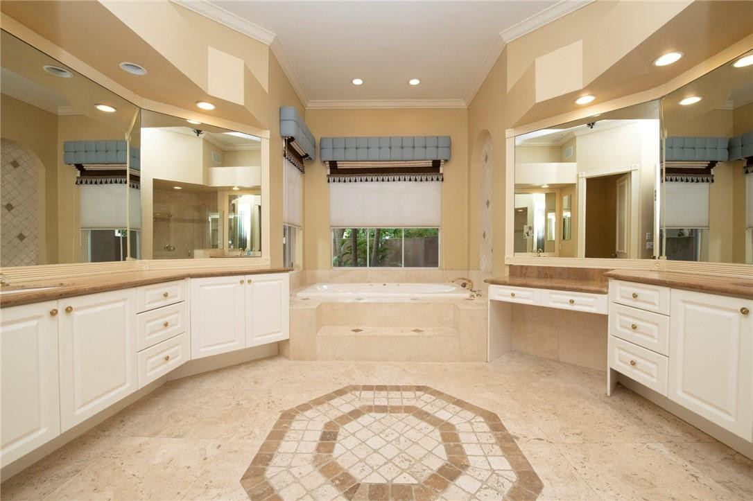6468 Northwest 31st Way Boca Raton, FL 33496 - Photo 17 of 43 a large white bathroom with a large tub sink and vanity