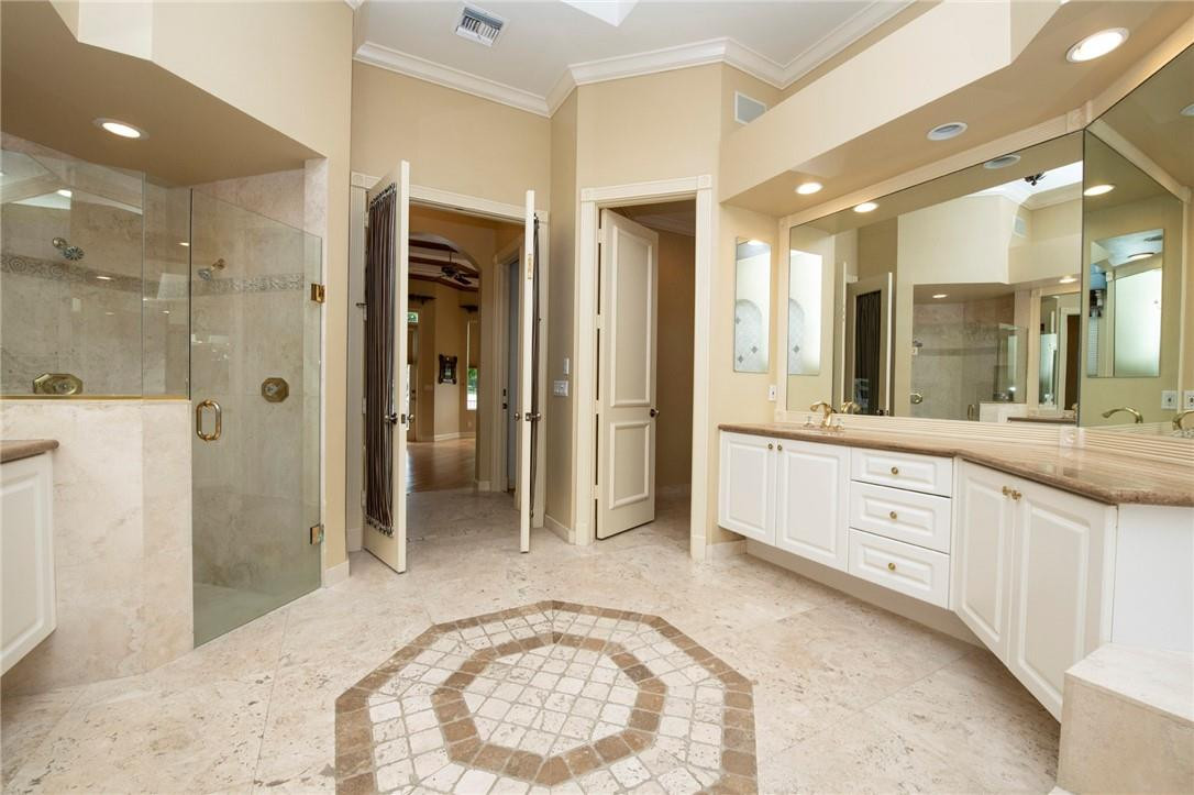 6468 Northwest 31st Way Boca Raton, FL 33496 - Photo 18 of 43 a spacious bathroom with a shower a sink and a mirror
