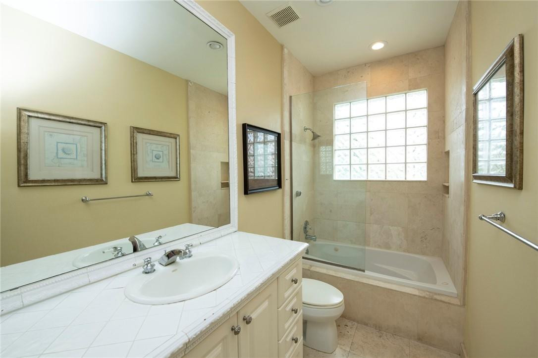 6468 Northwest 31st Way Boca Raton, FL 33496 - Photo 25 of 43 a bathroom with a sink a toilet and shower