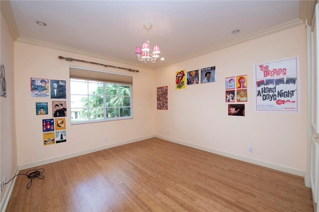 6468 Northwest 31st Way Boca Raton, FL 33496 - Photo 27 of 43 a view of an empty room with a window and wooden floor