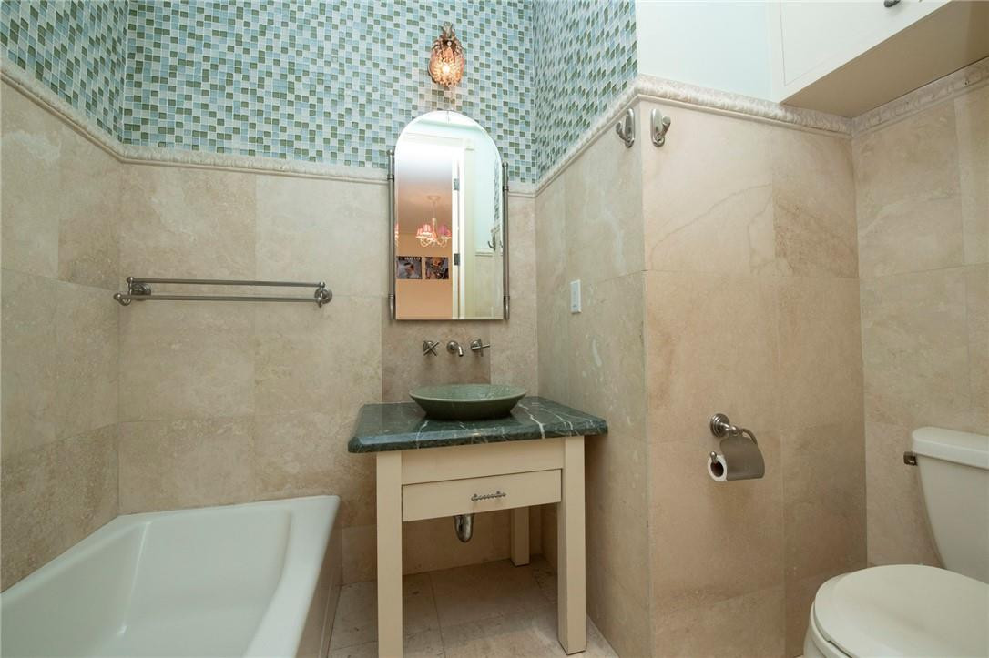 6468 Northwest 31st Way Boca Raton, FL 33496 - Photo 28 of 43 a bathroom with a granite countertop sink toilet and shower