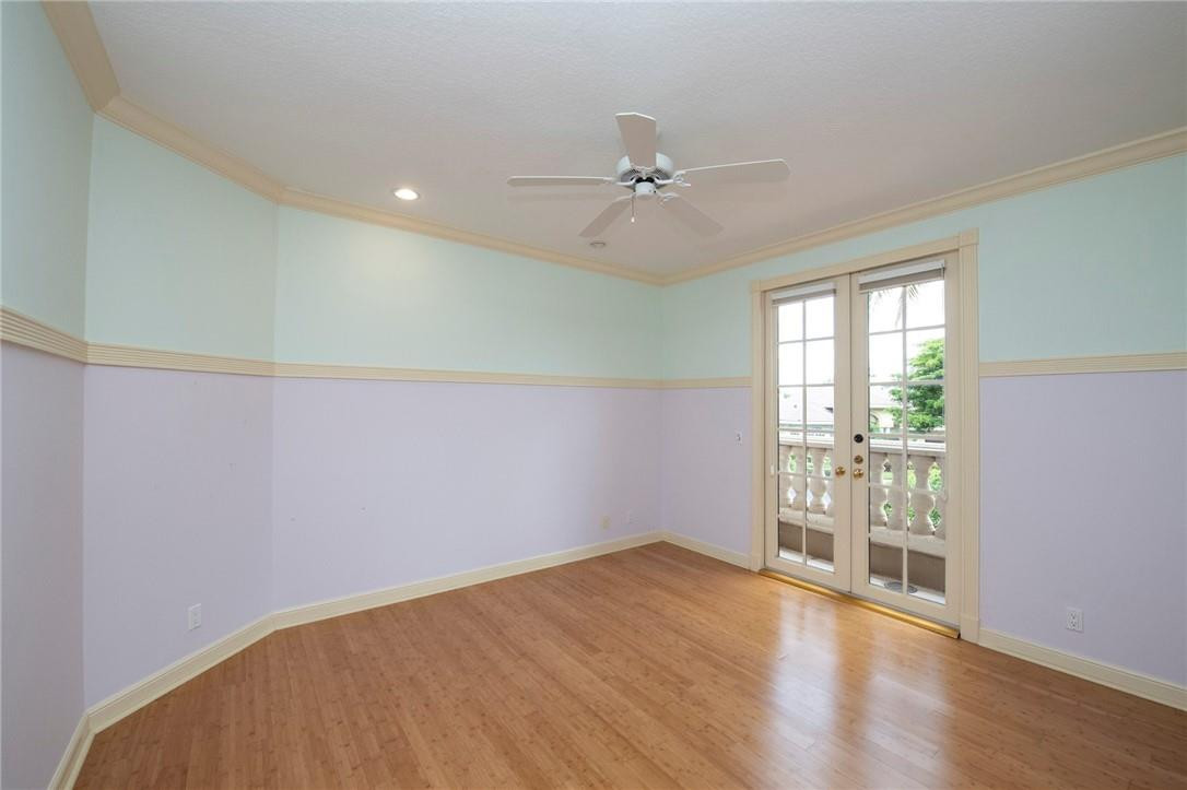 6468 Northwest 31st Way Boca Raton, FL 33496 - Photo 29 of 43 an empty room with wooden floor fan and windows