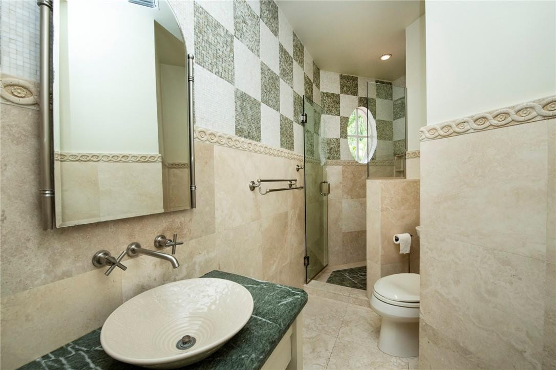 6468 Northwest 31st Way Boca Raton, FL 33496 - Photo 31 of 43 a bathroom with a granite countertop sink toilet a mirror and shower