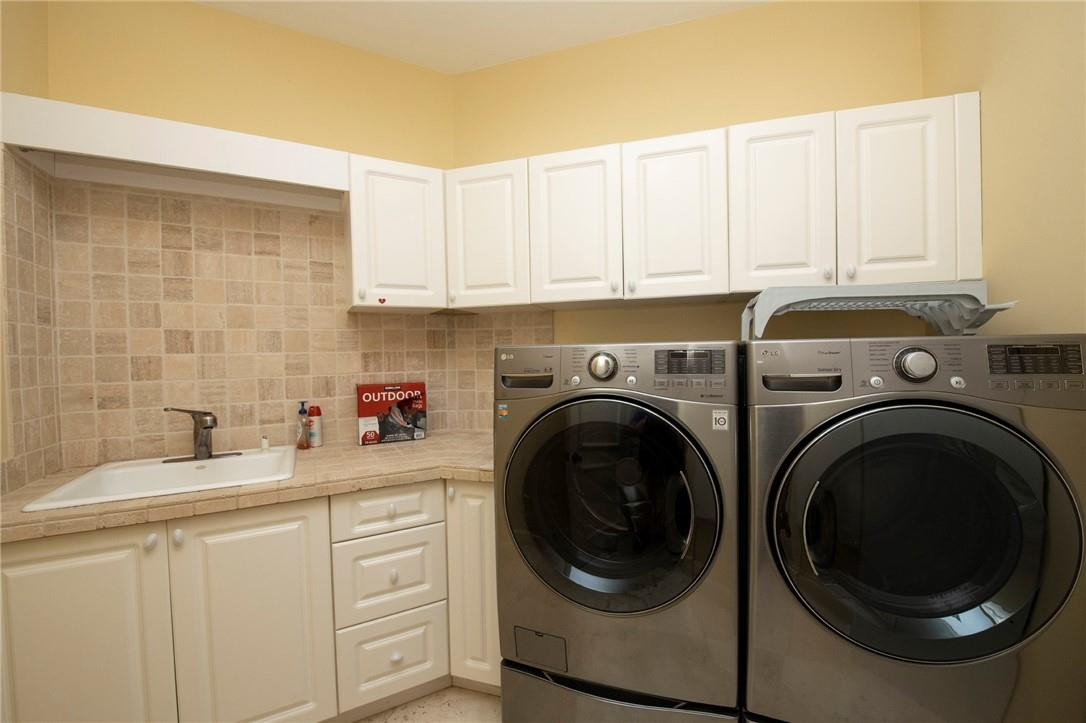 6468 Northwest 31st Way Boca Raton, FL 33496 - Photo 33 of 43 a utility room with sink dryer and washer