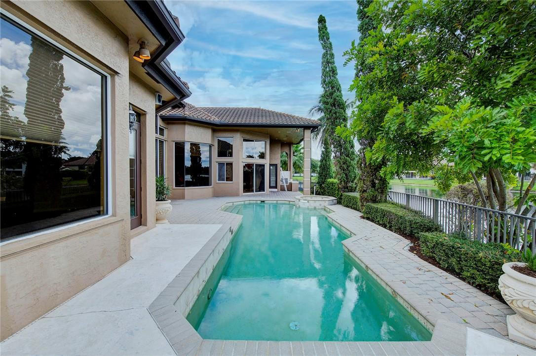 6468 Northwest 31st Way Boca Raton, FL 33496 - Photo 36 of 43 a view of a patio with couches table and chairs and potted plants
