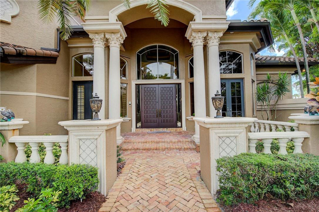 6468 Northwest 31st Way Boca Raton, FL 33496 - Photo 4 of 43 a front view of a house with large windows