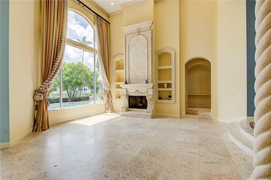 6468 Northwest 31st Way Boca Raton, FL 33496 - Photo 6 of 43 a view of an empty room with a fireplace and a window