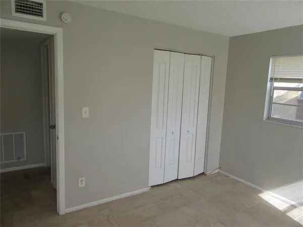 a view of an empty room and closet area