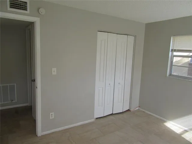 a view of an empty room and closet area