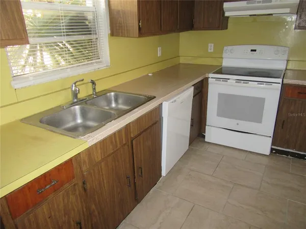 a utility room with a sink washer and dryer