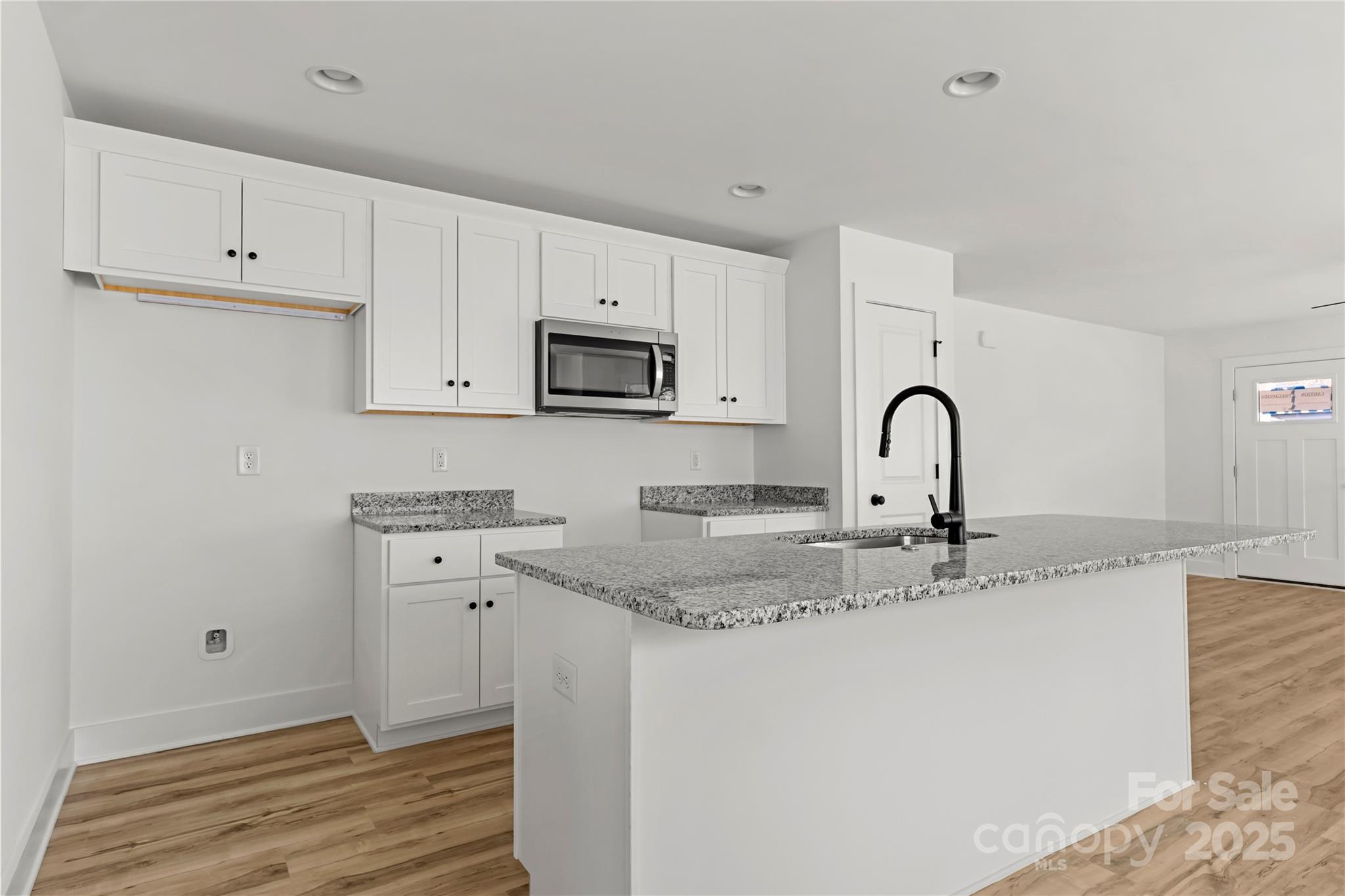 2022 4th Street Southwest Hickory, NC 28602 - Photo 11 of 31 a kitchen with stainless steel appliances granite countertop a sink a stove and cabinets
