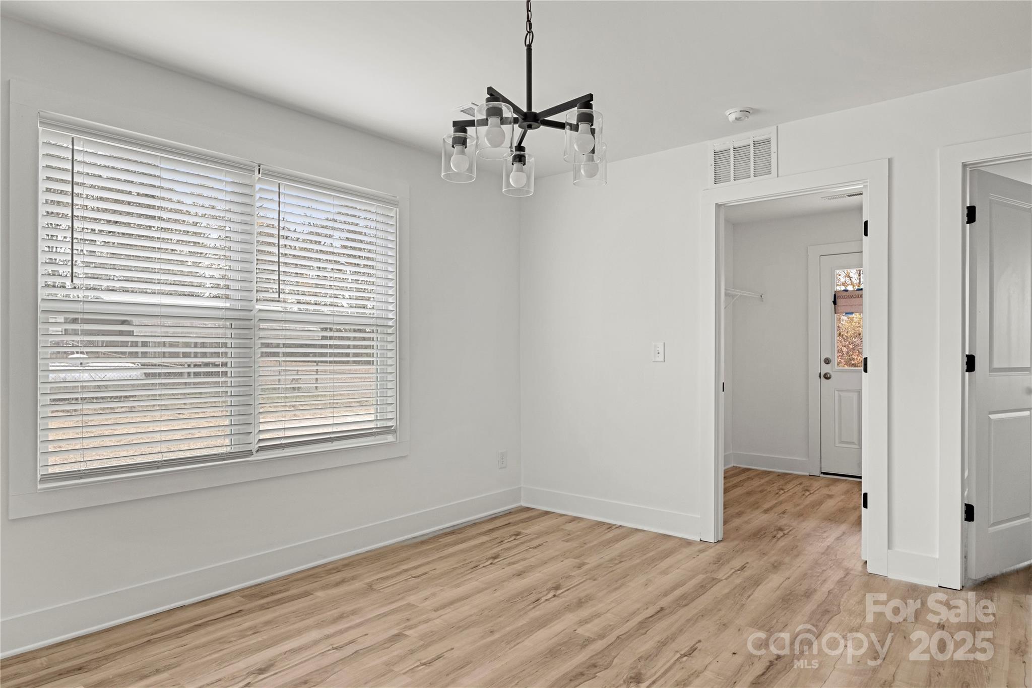 2022 4th Street Southwest Hickory, NC 28602 - Photo 13 of 31 a view of an empty room with wooden floor and a window