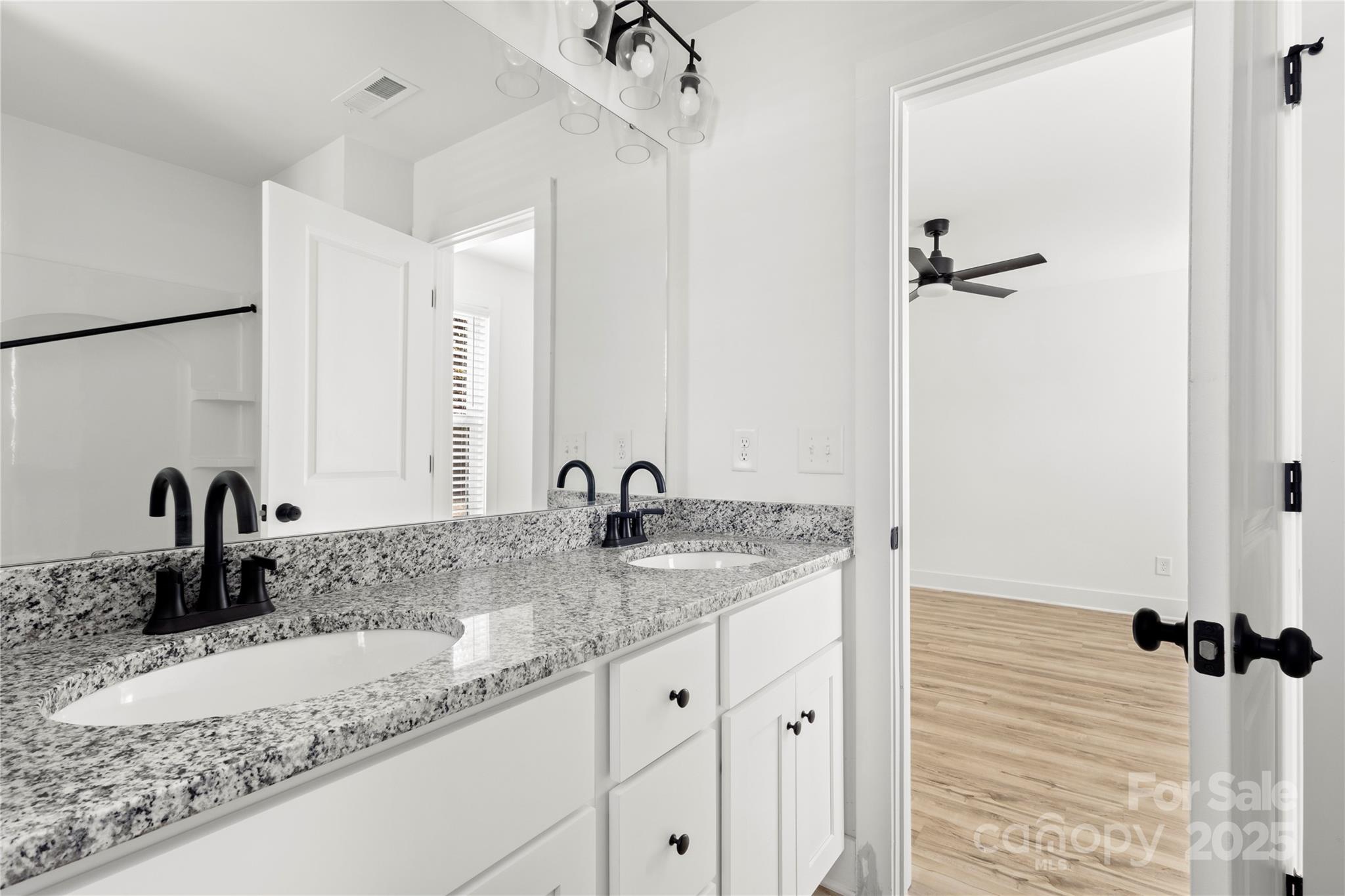 2022 4th Street Southwest Hickory, NC 28602 - Photo 19 of 31 a bathroom with a granite countertop sink and a mirror