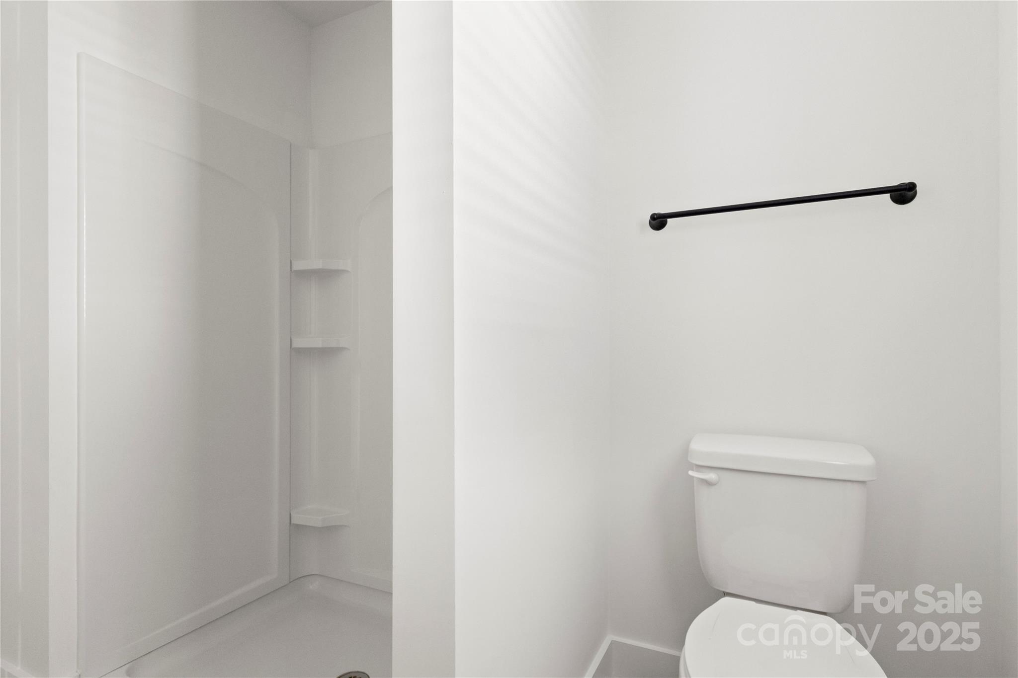 2022 4th Street Southwest Hickory, NC 28602 - Photo 20 of 31 a white toilet sitting next to a shower