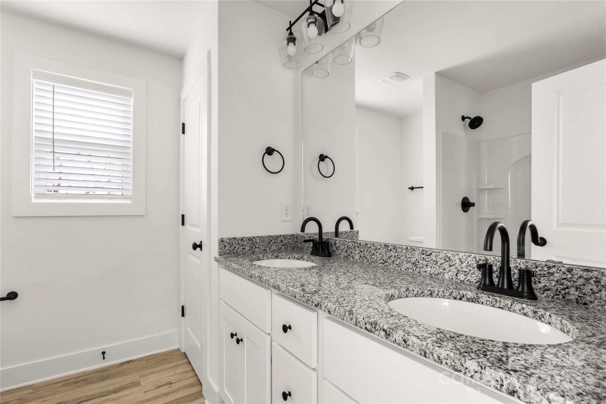 2022 4th Street Southwest Hickory, NC 28602 - Photo 22 of 31 a bathroom with a granite countertop sink and a mirror