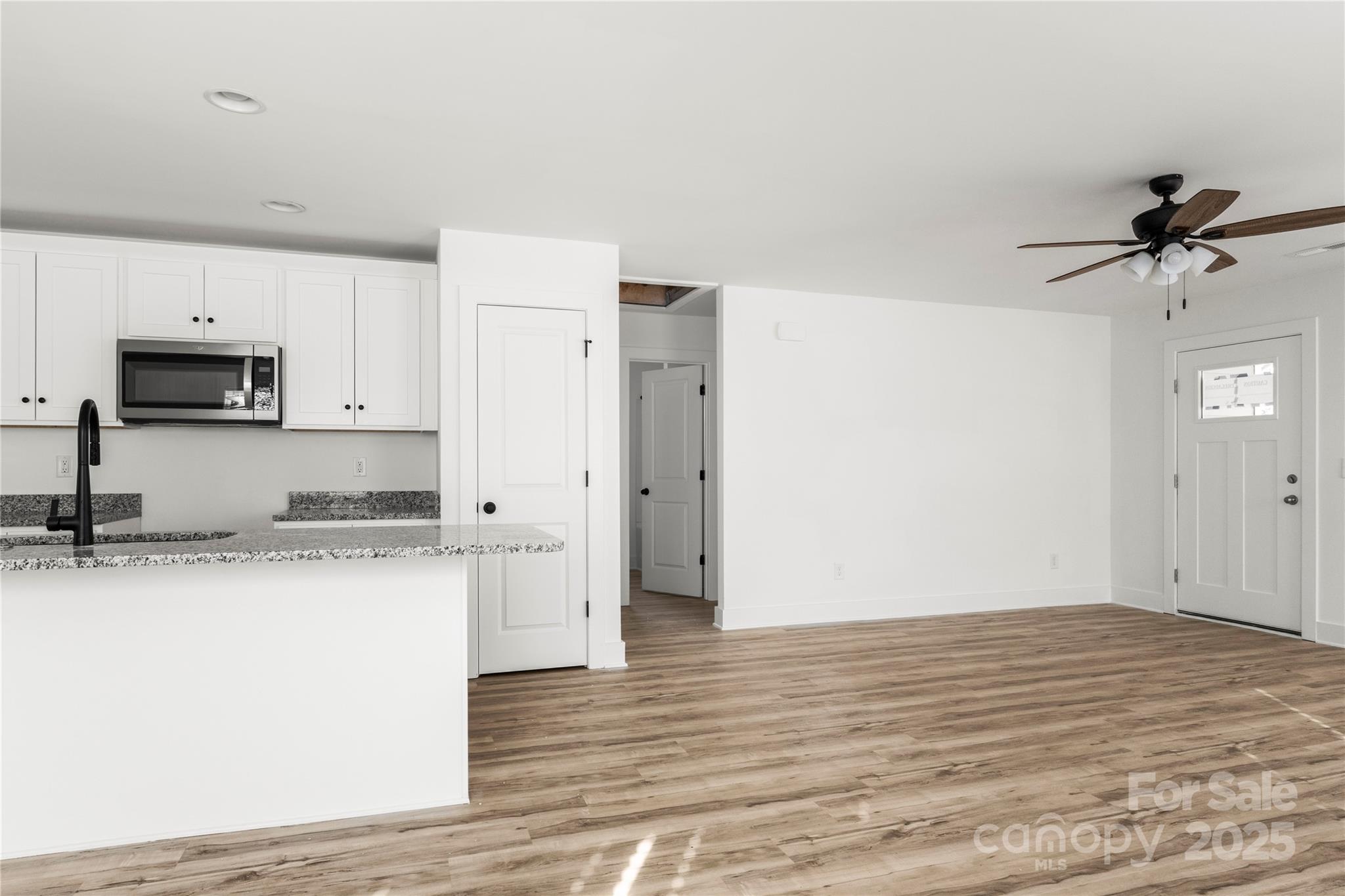 2022 4th Street Southwest Hickory, NC 28602 - Photo 24 of 31 a kitchen with granite countertop a sink cabinets and wooden floor