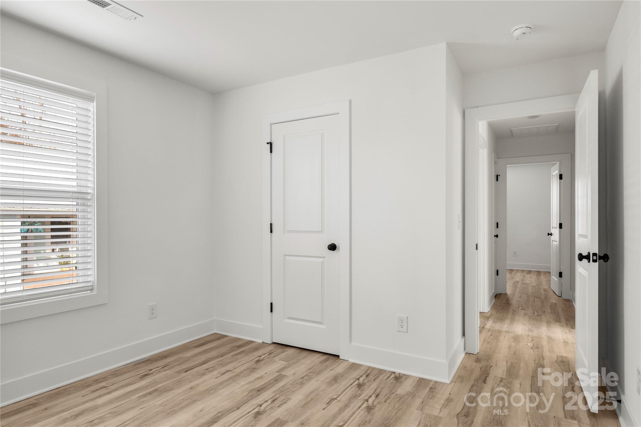 2022 4th Street Southwest Hickory, NC 28602 - Photo 26 of 31 a view of an empty room with wooden floor and a window