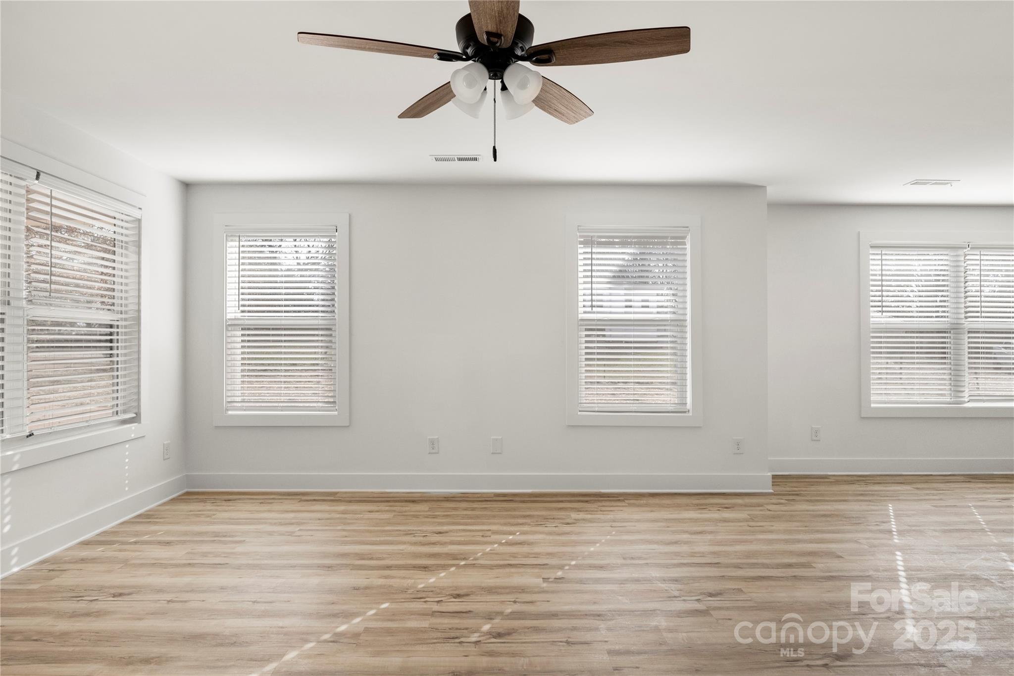 2022 4th Street Southwest Hickory, NC 28602 - Photo 5 of 31 a view of an empty room with a window and a ceiling fan