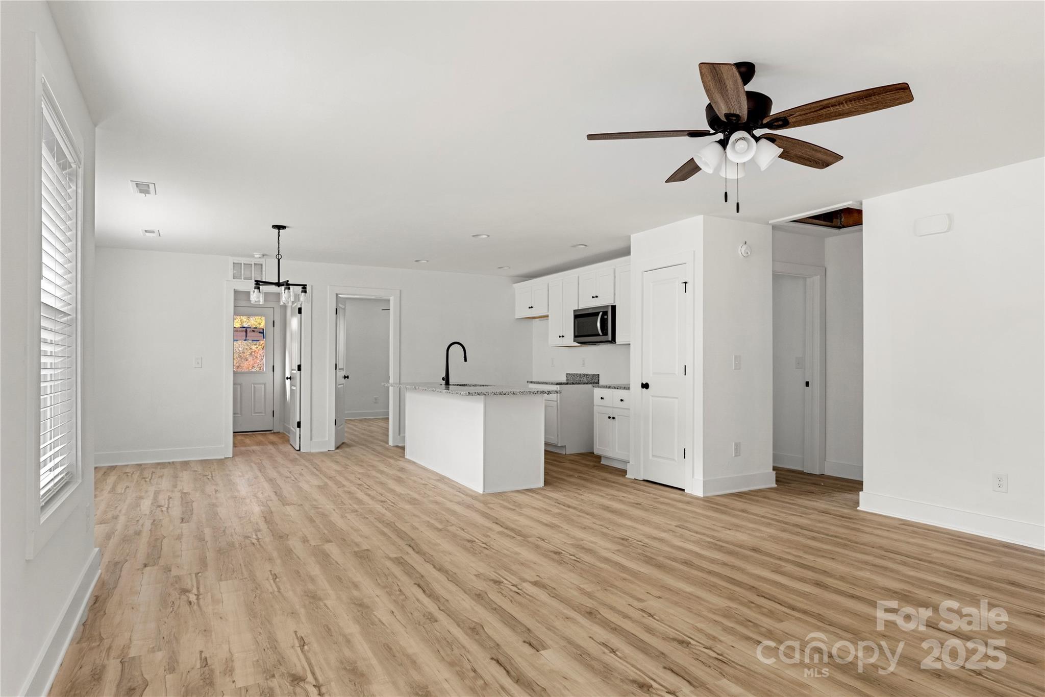 2022 4th Street Southwest Hickory, NC 28602 - Photo 6 of 31 a view of empty room with wooden floor and ceiling fan