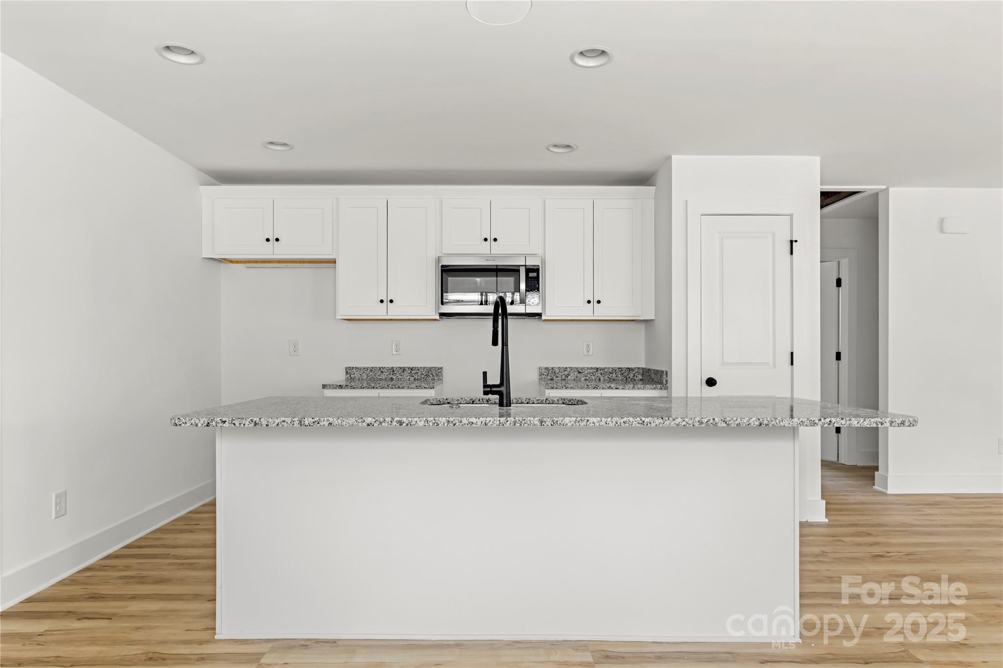 2022 4th Street Southwest Hickory, NC 28602 - Photo 10 of 31 a kitchen with stainless steel appliances granite countertop a sink a stove a refrigerator and white cabinets