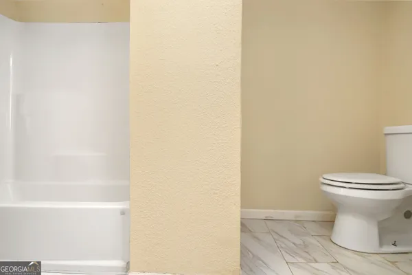 a bathroom with a toilet and a sink