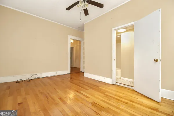 a view of an empty room with wooden floor