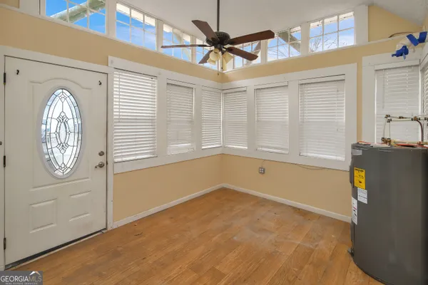 a view of empty room with window and fan