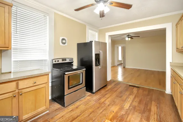 a kitchen with stainless steel appliances granite countertop a refrigerator and a stove top oven
