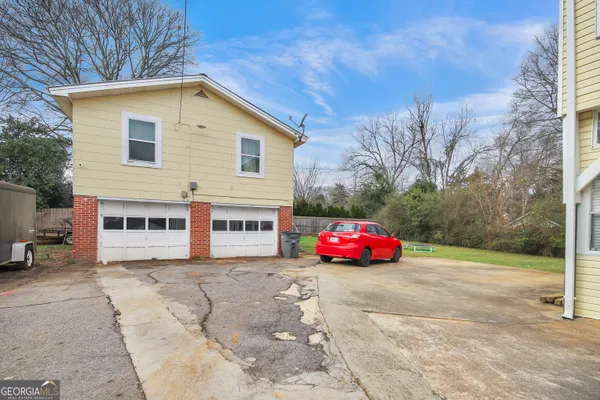 a front view of a house with cars parked