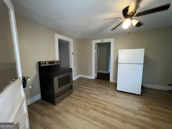 a living room with a bed furniture and a flat screen tv