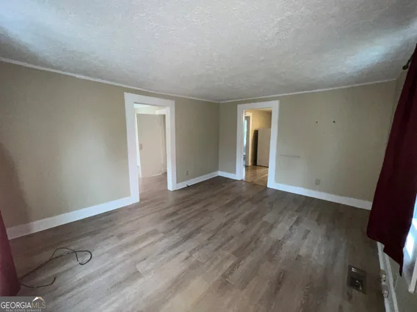 an empty room with wooden floor and closet