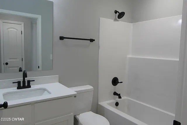 a bathroom with a sink a toilet and a bathtub