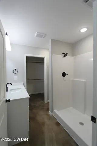a bathroom with a bathtub sink and mirror
