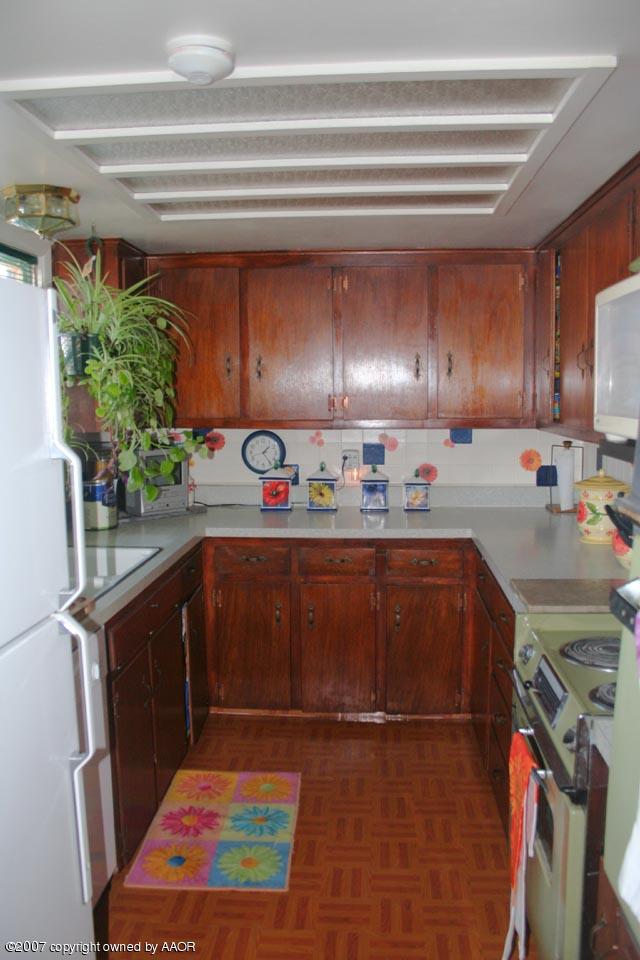 4717 South Milam Street Amarillo, TX 79110 - Photo 3 of 10 a kitchen with stainless steel appliances granite countertop a refrigerator stove and sink