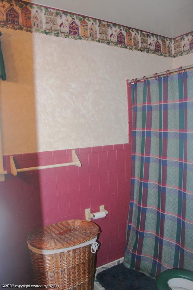 4717 South Milam Street Amarillo, TX 79110 - Photo 9 of 10 a bathroom with a sink and a shower