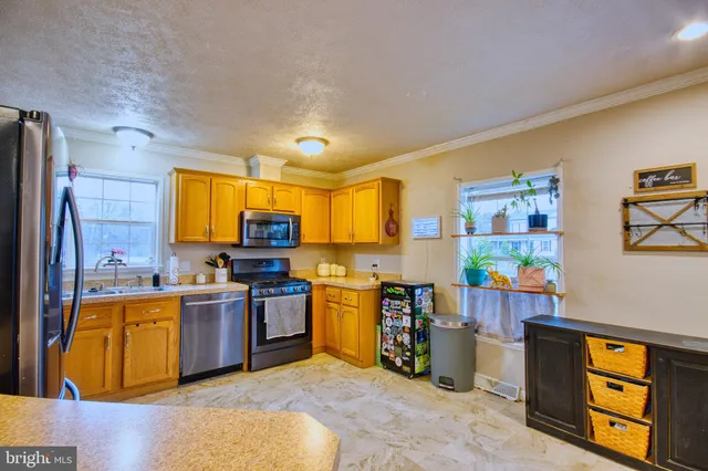 a kitchen with stainless steel appliances granite countertop a stove and a sink