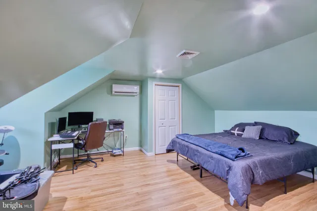 a bedroom with a bed and a desk