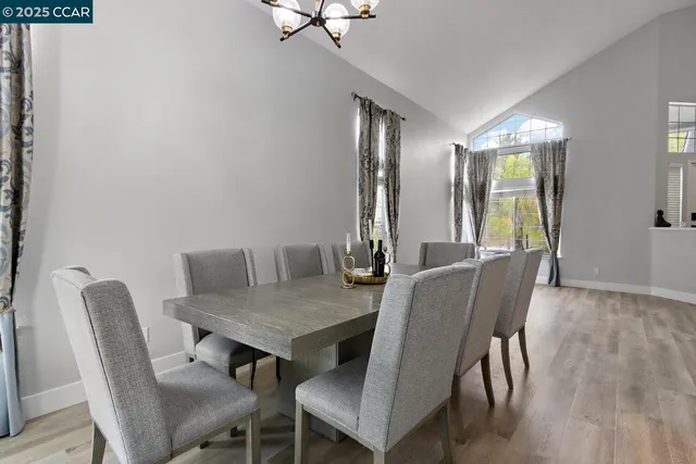a kitchen with a refrigerator and a stove top oven