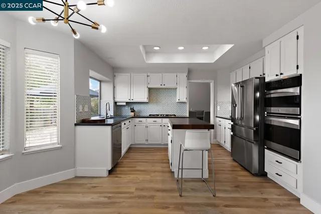 a kitchen with a large window and a sink