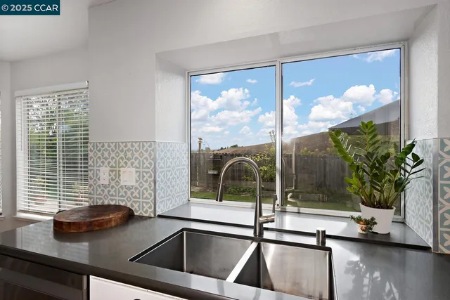 a kitchen with granite countertop a stove cabinets and wooden floor